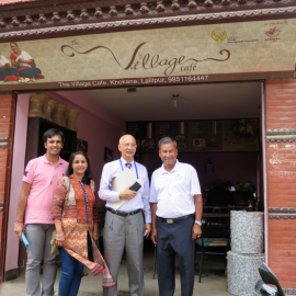 Rotarians managing the grant in front of the village cafe that is managed by Khokana Women Awareness Society (KWAS)